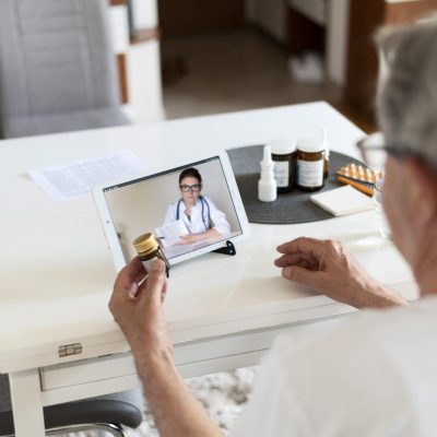 close-up-old-man-talking-online-doctor-scaled.jpg
