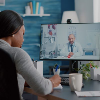 young-woman-writing-respiratory-sickness-treatment-notebook-discussing-pills-treatment-during-online-healthcare-videocall-2-scaled.jpg